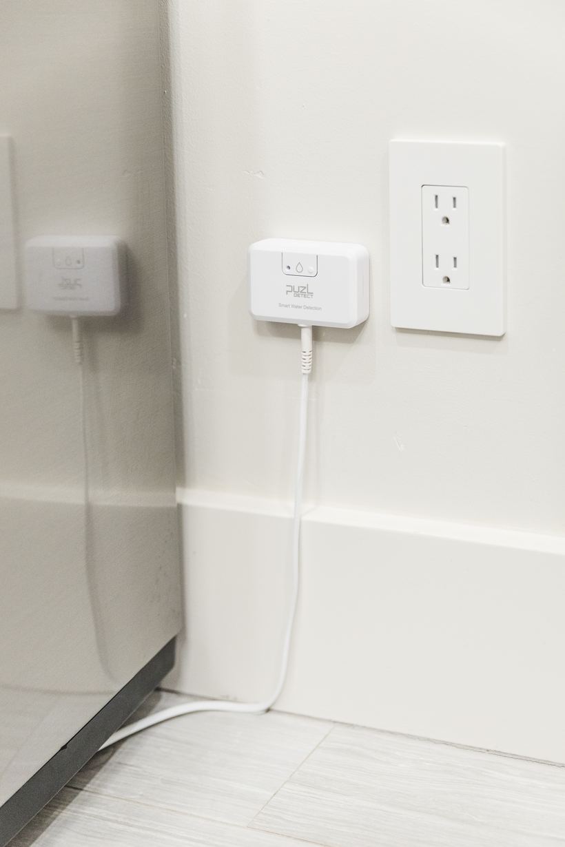 Two PuzL Detect units along the wall beside an appliance